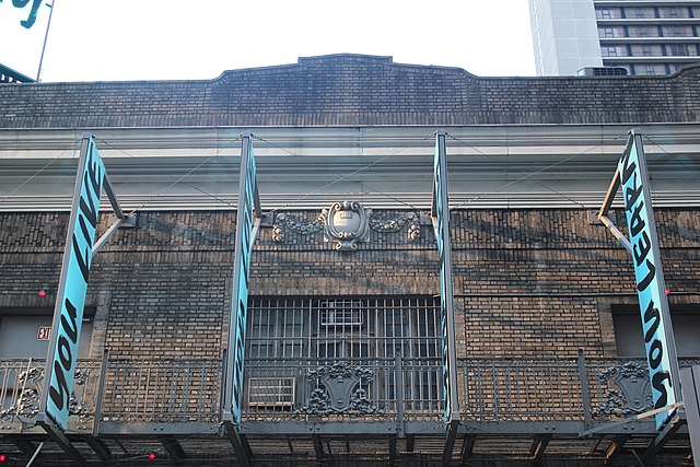 Fire escape on third story, with parapet above