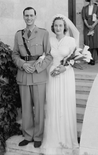 Groom wearing military uniform, with his bride in 1942
