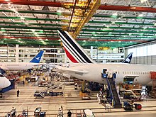 Several Boeing 787 Dreamliner aircraft under construction inside the Boeing South Carolina final assembly building 787 Assembly Line Tails (32910230421).jpg