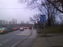 ŽST Lamač public bus stop in Bratislava. The actual bus stops (in both directions) are marked by red buses