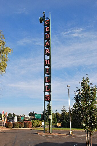 The neon sign tower at the Cedar Hills Shopping Center is a local landmark.
