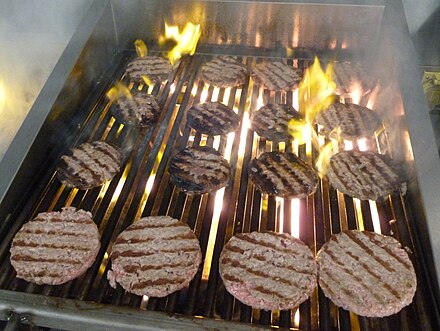 Hamburgers cooking on a charbroiler