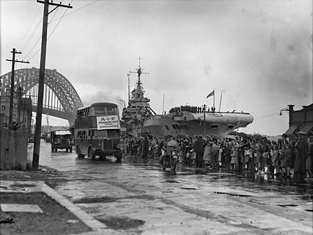 Friends and relatives of repatriated Australian POWs wave them off as they depart in buses after disembarking from Formidable at Sydney in October 1945
