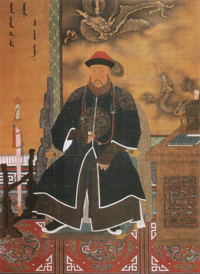 Three-quarter painted portrait of a thickly bearded man wearing a red hat adorned with a peacock feather and dressed with a dark long robe with dragon patterns. Clockwise from bottom left to bottom right, he is surrounded by a sheathed sword mounted on a wooden display, Manchu writing on the wall, a three-clawed dragon and a five-clawed dragon (also printed on the wall), and a wooden desk with an incense burner and a book on it.