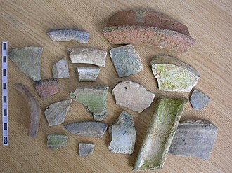 Early Medieval Stamford ware sherds, "dating to 10-11th century. The group includes many rouletted and pseudo-rouletted rims and shoulder sherds. These and an inverted rim sherd, suggest a pre conquest date". Found in Rutland. Early Medieval Stamford ware sherds (FindID 499542).jpg