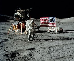 The first image is: a successful moon landing in full color containing the: American flag, 