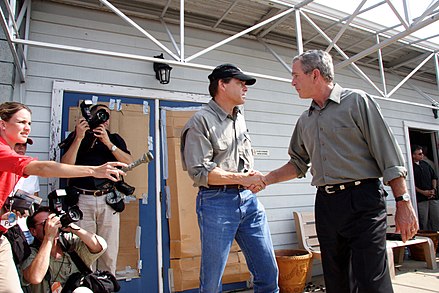 President George W. Bush and Texas Governor Rick Perry shake hands September 27, 2005, after a question-and-answer session at the Port Arthur airport. Port Arthur suffered extensive damage from Hurricane Rita.