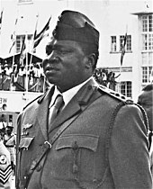 Idi Amin stands in military uniform