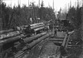 Loggers loading flatbed railcar using gin pole, Washington, 1909-1910 (INDOCC 1407).jpg