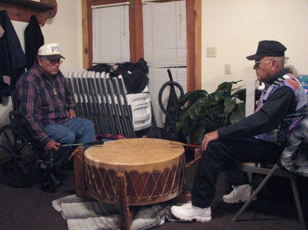 Mac Silverhorn (Comanche), grandson of Silver Horn, drumming with friend at Redstone Baptist Church