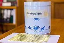 The biscuit tin and numbered counters used to select new member's bill in New Zealand Members bill biscuit tin, NZ Parliament.jpg