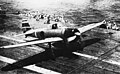 This A6M2 Model 21 Zero launches from the carrier Shokaku on October 26, 1942 during the Battle of the Santa Cruz Islands while deck crewmen cheer on the pilot, Lt Hideki Shingo.