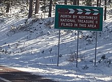 A sign on the road approaching Mount Rushmore North by Northwest and National Treasure II sign at Mount Rushmore.jpg