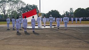 Paskibraka extending the national flag before it is raised PENGIBARAN SANG MERAH PUTIH.jpg