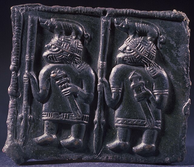 Warriors wearing boar-crested helmets on a Torslunda plate, dated to between the 6th and 8th century CE.
