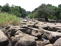 Water flows thru the rocks to the edge, rocks which are abraded by the omnipresent waters outside of Kacimbo