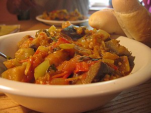 A bowl of ratatouille with bread