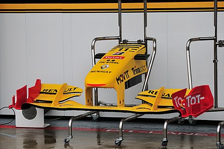 A low downforce spec. front wing on the Renault R30 F1 car. Front wings heavily influence the cornering speed and handling of a car, and are regularly changed depending on the downforce requirements of a circuit.