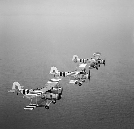 Three rocket-armed Swordfish on a training flight, August 1944. The aircraft are painted with Invasion stripes