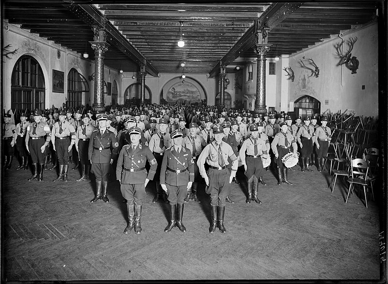 File:SS Schutzstaffel at attention Group portrait Beer hall 1. SS-Standarte Munich Germany c. 1933 Nazi Party NSDAP paramilitary uniforms Propaganda US National Archives NARA Unrestricted use 242-HF-0093 001.jpg