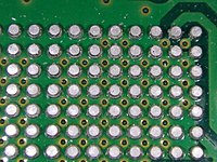 A grid array of solder balls under an integrated circuit chip, with the chip removed; the balls were left attached to the printed circuit board. Solder ball grid.jpg