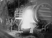 Pouring from a Peirce-Smith copper converter, Mount Isa, 1954. StateLibQld 1 297295 Inside the smelting works at Mount Isa, 1954.jpg