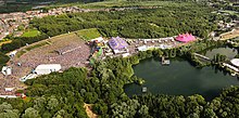 An aerial photograph of part of the Tomorrowland site, including the main stage to the left, 2012 TomorrowLand - A Look From The Sky (13891384681).jpg