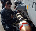 US Navy 111012-N-UD469-005 Aviation Ordnanceman 2nd Class Christopher Streeter loads a torpedo on an SH-60F Sea Hawk helicopter assigned to the War.jpg