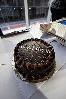 Photographie d'un gâteau au chocolat portant l'inscription « Wikicurious ».