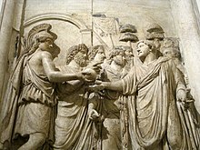 Relief from an honorary monument of Hadrian (detail), showing the emperor being greeted by the goddess Roma and the Genii of the Senate and the Roman People; marble, Roman artwork, 2nd century AD, Capitoline Museums, Vatican City 0 Monument honoraire d'Hadrien - L'empereur accueilli par la deesse Rome (2).JPG