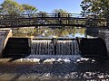 Thumbnail for File:2023-10-13 11 03 51 The pedestrian bridge over the spillway of Peddie Lake in Hightstown, Mercer County, New Jersey.jpg