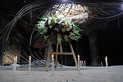 Candles lit near the bomb's entry hole in February 2021, commemorating the 30th anniversary of the bombing 30th commemoration.jpg