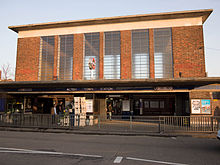 Front view of the station. Note the London Underground Roundel sign mounted on the flat canopy. Acton Town station (exterior) - Flickr - James E. Petts.jpg