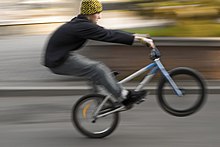 A bicyclist performing a wheelie. Bicycle motocross.jpg