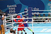 Deutsch: Boxen bei den Olympischen Jugendspielen 2018 Tag 12, 18. Oktober 2018 - Finale Fliegengewicht Mädchen – Martina La Piana (Italien, blau) schlägt Adijat Gbadamosi (Nigeria, rot) 5-0; Ringrichter ist James Beckles (Trinidad und Tobago). English: Boxing at the 2018 Summer Youth Olympics on 18 October 2018 – Girl's flyweight Gold Medal Bout - Martina La Piana (Italy, blue) beats Adijat Gbadamosi (Nigeria, red) 5-0; Referee is James Beckles (Trinidad and Tobago). Español: Boxeo en los Juegos Olímpicos Juveniles de Verano de 2018 en 18 de octubre de 2018 - Combate a medalla de oro de peso mosca para mujeres: Martina La Piana (Italia, azul) le gana a Adijat Gbadamosi (Nigeria, roja) 5-0; El árbitro es James Beckles (Trinidad y Tobago).