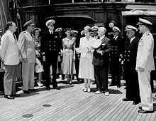 Marjorie Merriweather Post and her husband, Ambassador Joseph E. Davies, at center, with Carton Skinner at a presentation of a Naval Reserve Pennant.