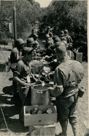 CASA soldiers enjoy a meal prepared by the mess section. Civil Affairs Staging Area (CASA) Soldiers Field Mess.PNG