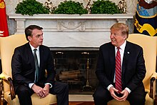 Brazilian President Jair Bolsonaro and United States President Donald Trump in 2019. Both are emblematic of a wave of neo-nationalist and globalisation-weary conservative populism in the second half of the decade. Encontro com o Senhor Donald Trump, Presidente dos Estados Unidos da America (47422559941).jpg