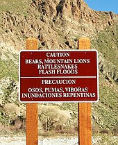Bilingual English-Spanish sign in the Colorado Desert of Southern California. Espanol-English caution sign in the Californian Desert.jpg
