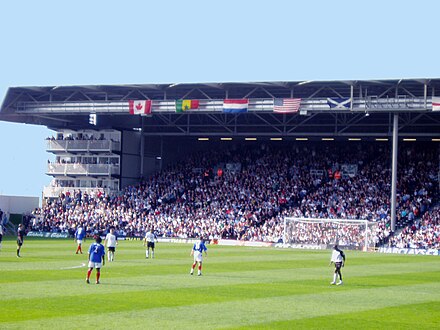 Fulham (white) playing Portsmouth (blue) in front of Fulham fans in the Hammersmith End