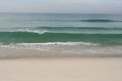 Gentle waves come in at a sandy beach.JPG