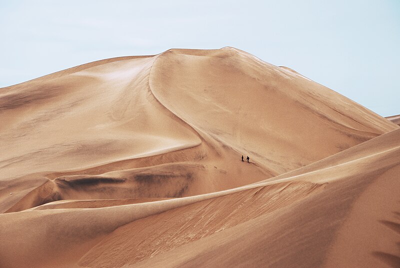 File:Hiking Through Sand Dunes (Unsplash).jpg