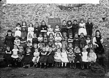 Infants class at a school in Llandovery, Carmarthenshire (1891) Infants of the British school, Llanymddyfri NLW3363471.jpg