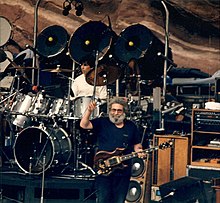 Grateful Dead performing at Red Rocks Amphitheatre in 1987: Jerry Garcia (custom Tiger guitar), Mickey Hart (drums). Jerry-Mickey at Red Rocks taken 08-11-87.jpg