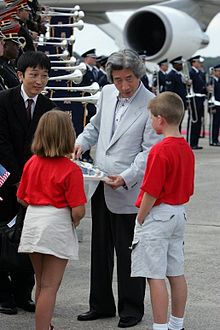 Koizumi meets children at the airport, shortly before the 2004 G8 summit.
