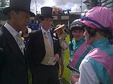 Lord Grimthorpe (centre) talking to jockeys Ian Mongan and Tom Queally at Royal Ascot in 2012. Sir Henry Cecil is to Lord Grimthorpe's right. Lord Grimthorpe.jpg