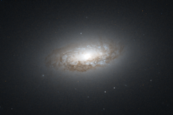 HST image of the dust disk in NGC 4476. NGC 4476 HST 9401 R850B475.png