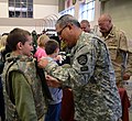 Oregon State Defense Force member helps child try on armor.jpg