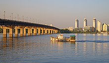 Paton Bridge, the Dnieper River and the Berezniaky neighbourhood at sunset. Kiev, Ukraine.jpg