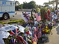 Flags, photos, flowers, and wreaths